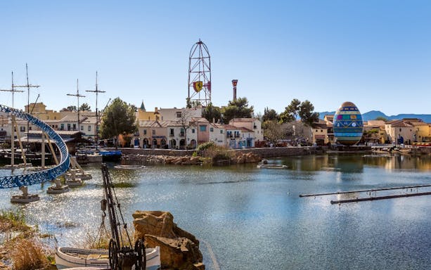 PortAventura Park lake view with roller coaster and Ferrari Land tower in the background.
