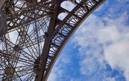 Eiffel Tower iron lattice detail against blue sky, Paris.