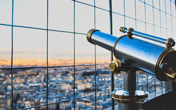 Viewing telescope on Eiffel Tower 2nd floor overlooking Paris.