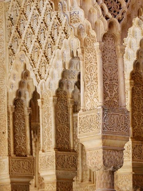 Intricate Moorish arches in the Nasrid Palaces, Alhambra, Granada.