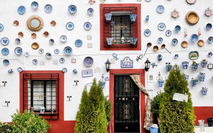 Ceramic plates and pots on a white wall in Albaicin, Granada.