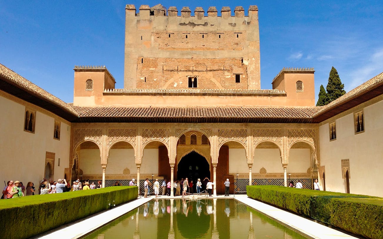 Alhambra's Nasrid Palaces courtyard with reflecting pool, Granada, Spain.