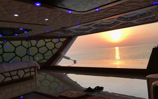 Interior view of Mega Yacht with sunset over the ocean, part of Westin dinner cruise.
