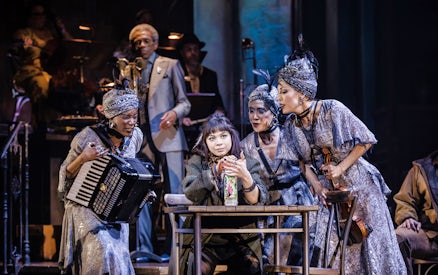 Performers on stage during a scene from Hadestown musical.