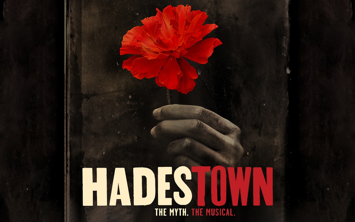 Hand holding a red flower with "Hadestown" text below.