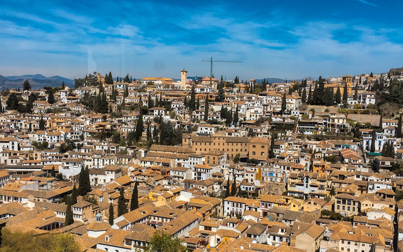 Granada cityscape with historic buildings and Alhambra view on Tapas Walking Tour.