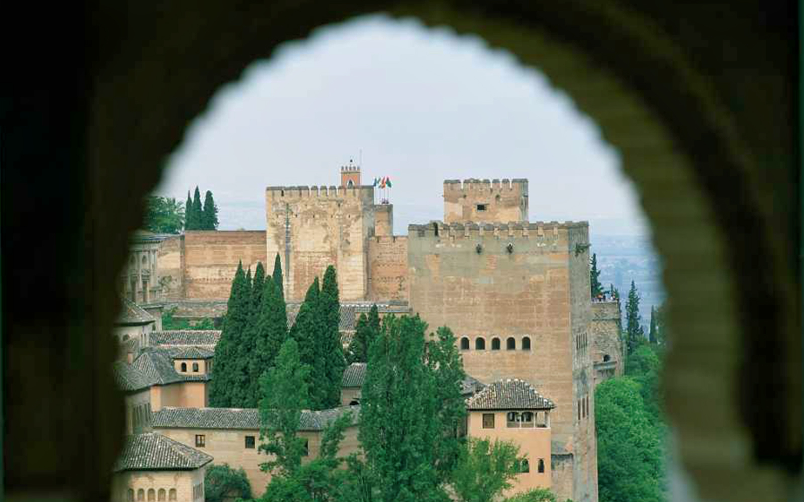 Alhambra fortress view through archway, Granada, Spain.