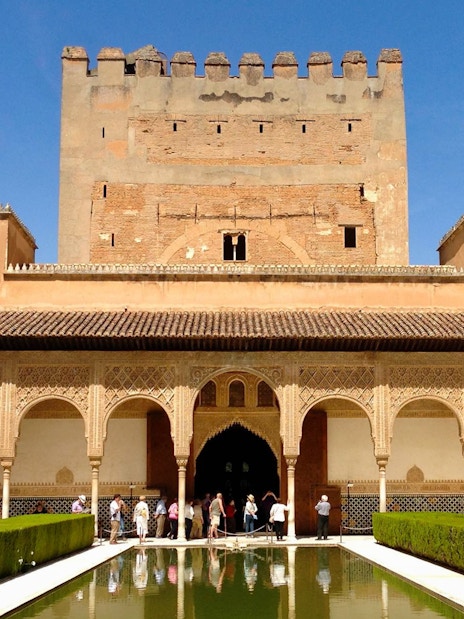 Alhambra courtyard with reflecting pool and Nasrid Palaces, Granada, Spain.