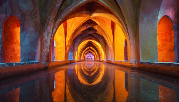 Real Alcazar Seville courtyard with intricate arches on skip-the-line guided tour.