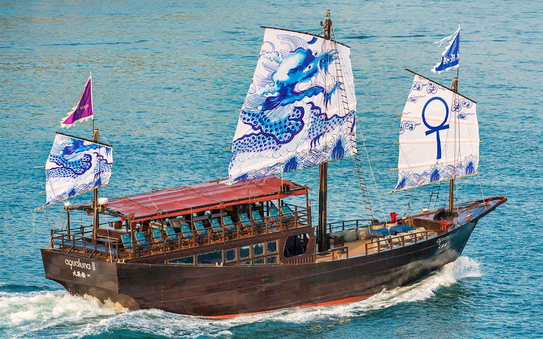 Traditional Chinese junk boat AquaLuna sailing in Stanley Bay, Hong Kong.