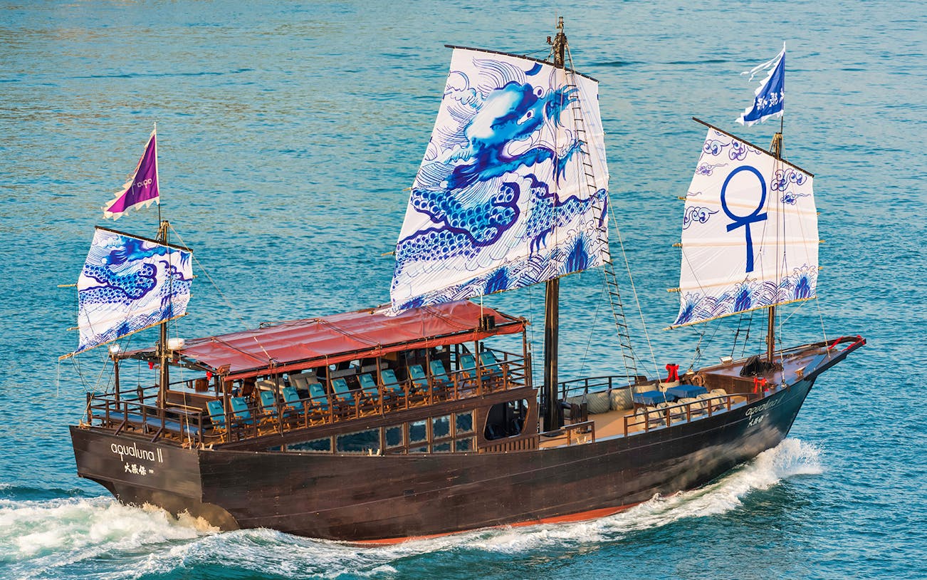 Traditional Chinese junk boat AquaLuna sailing in Stanley Bay, Hong Kong.