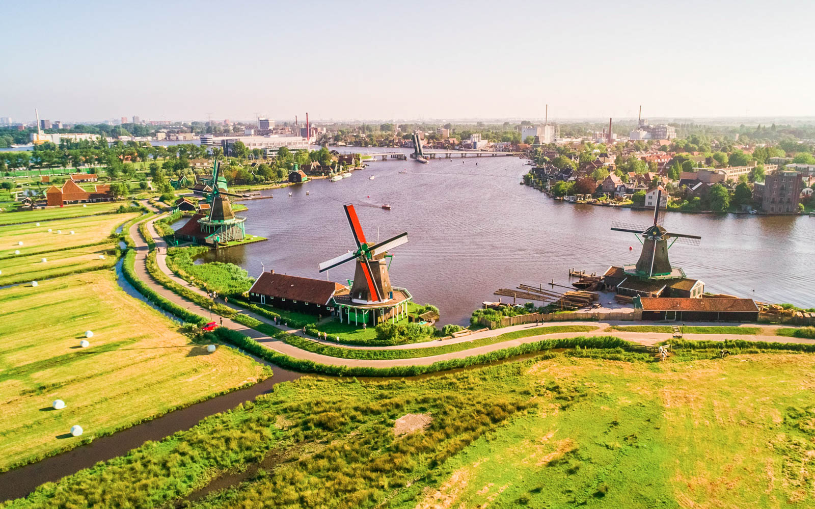 Windmills along the river at Zaanse Schans near Amsterdam, showcasing traditional Dutch architecture.