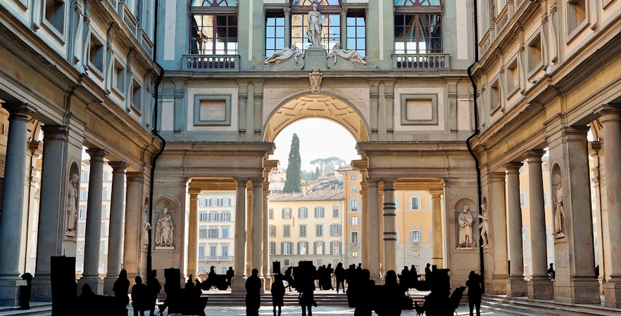 Uffizi Gallery courtyard with visitors in Florence, Italy.