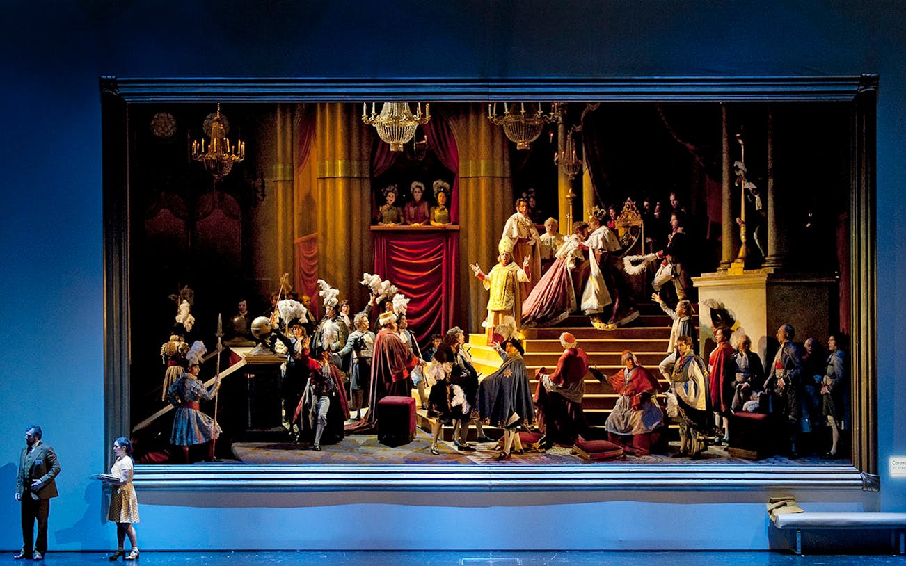 Opera scene from "Il viaggio a Reims" with performers in period costumes on stage.