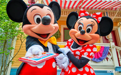 Mickey and Minnie Mouse at Disney Park offering tickets.