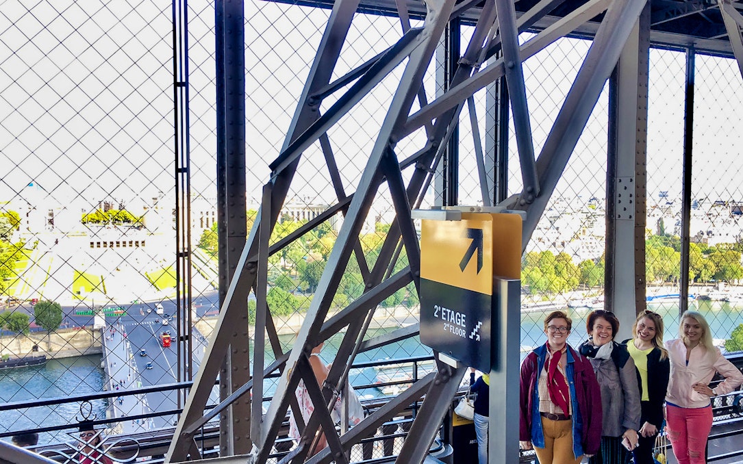 Eiffel Tower elevator view with tourists on the second floor, Paris.