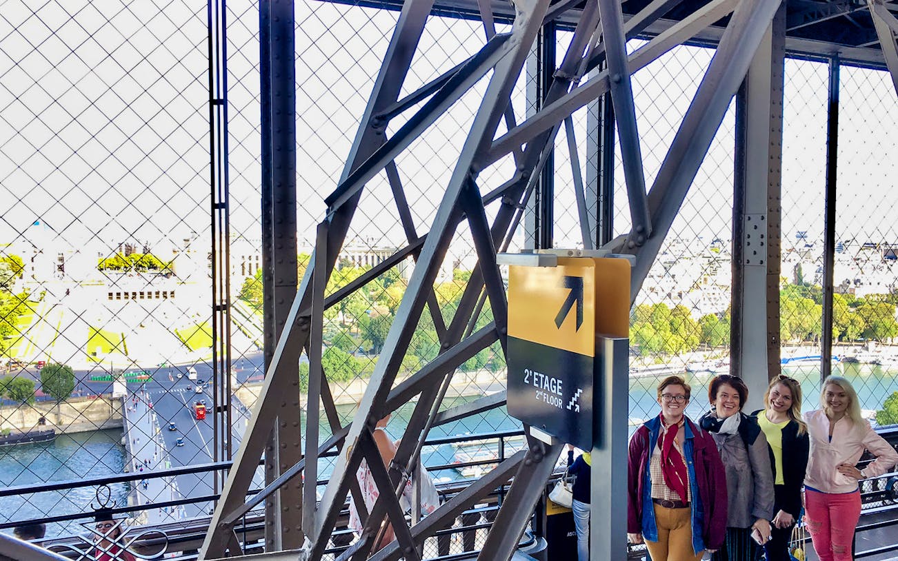 Eiffel Tower elevator view with tourists on the second floor, Paris.