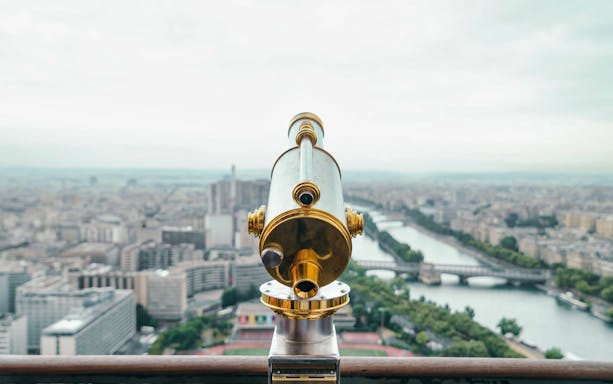 Telescope view from Eiffel Tower overlooking Paris and Seine River.