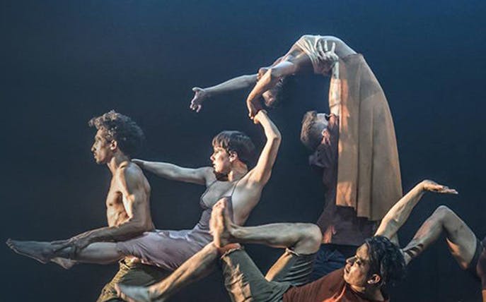 Dancers performing an intricate lift in "Message In A Bottle" show.