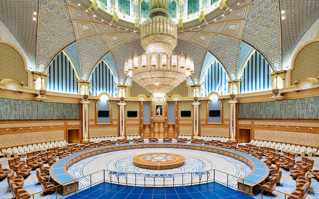 Interior of Qasr Al Watan's grand hall with ornate ceiling and chandelier, Abu Dhabi.