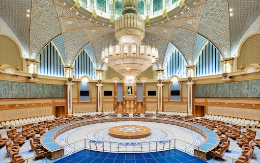 Interior of Qasr Al Watan's grand hall with ornate ceiling and chandelier, Abu Dhabi.