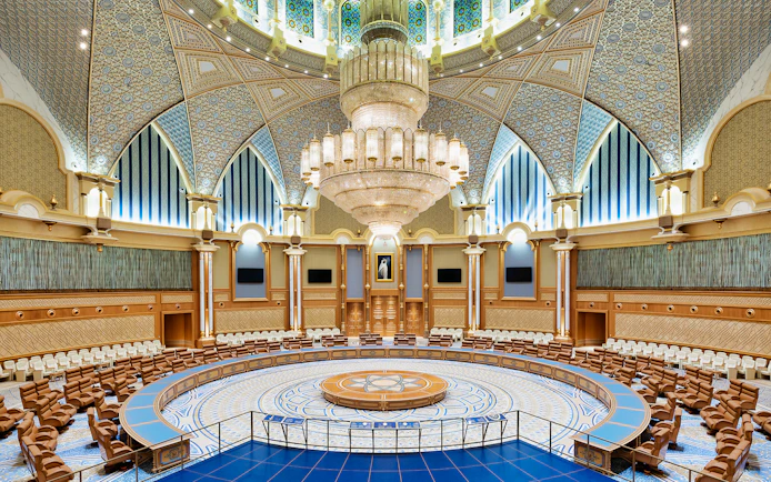 Interior of Qasr Al Watan's grand hall with ornate ceiling and chandelier, Abu Dhabi.