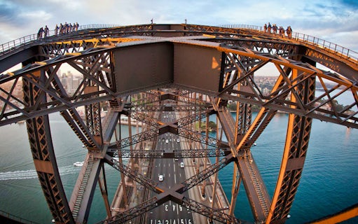 Climbers on Sydney Harbour Bridge during BridgeClimb Summit with city and water views.