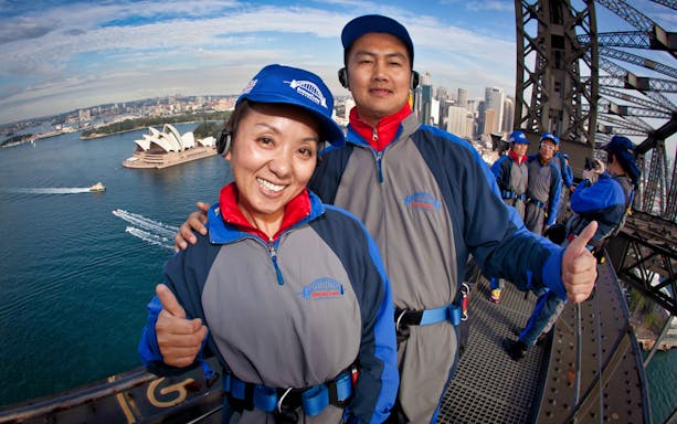 Climbers on Sydney Harbour Bridge with Opera House view during BridgeClimb Summit.