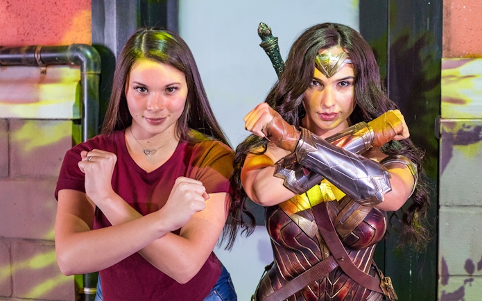 Person posing with Wonder Woman figure at Madame Tussauds Sydney.