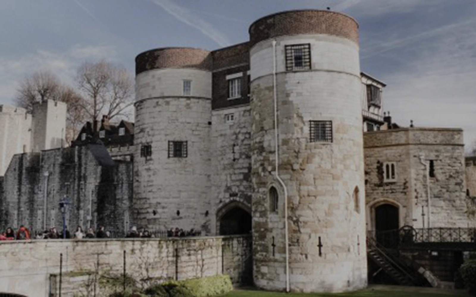 Tower of London entrance with stone walls and round towers, early access tour.