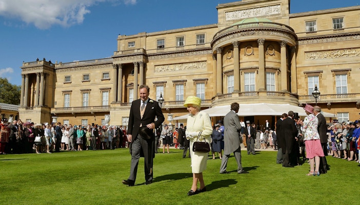 Buckingham Palace garden event with guests, related to the Changing of the Guard tour.