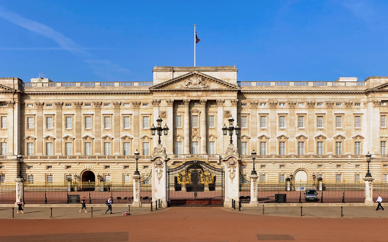 Changing of the Guard ceremony at Buckingham Palace, London, with Westminster Dome in the background.