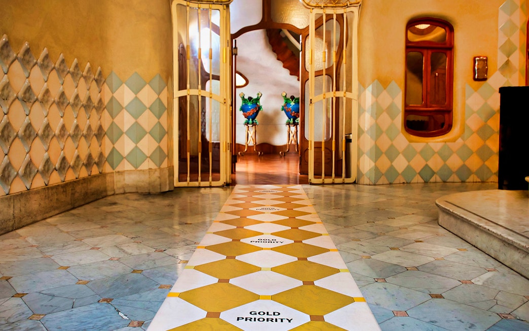 Casa Batlló interior with decorative tiles and open doors in Barcelona.