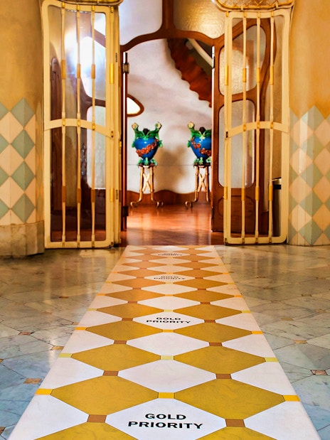 Casa Batlló interior with decorative tiles and open doors in Barcelona.