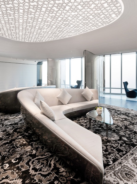 Lounge area with modern seating and patterned ceiling at Burj Khalifa, Dubai.