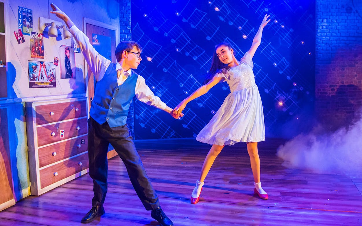 Young performers dancing on stage in "The Secret Diary of Adrian Mole Aged 13 3/4" musical.
