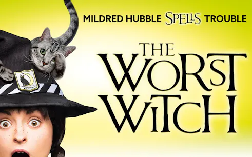 Mildred Hubble with a cat on her hat, promoting "The Worst Witch" show.