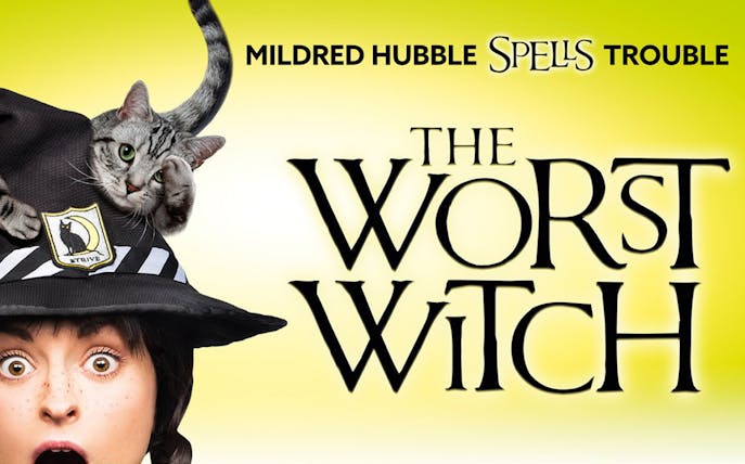 Mildred Hubble with a cat on her hat, promoting "The Worst Witch" show.