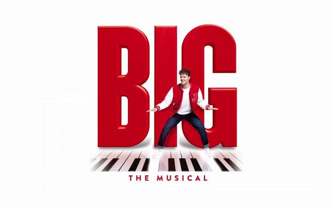 Performer in front of large red letters spelling "BIG" with piano keys, promoting Big The Musical.