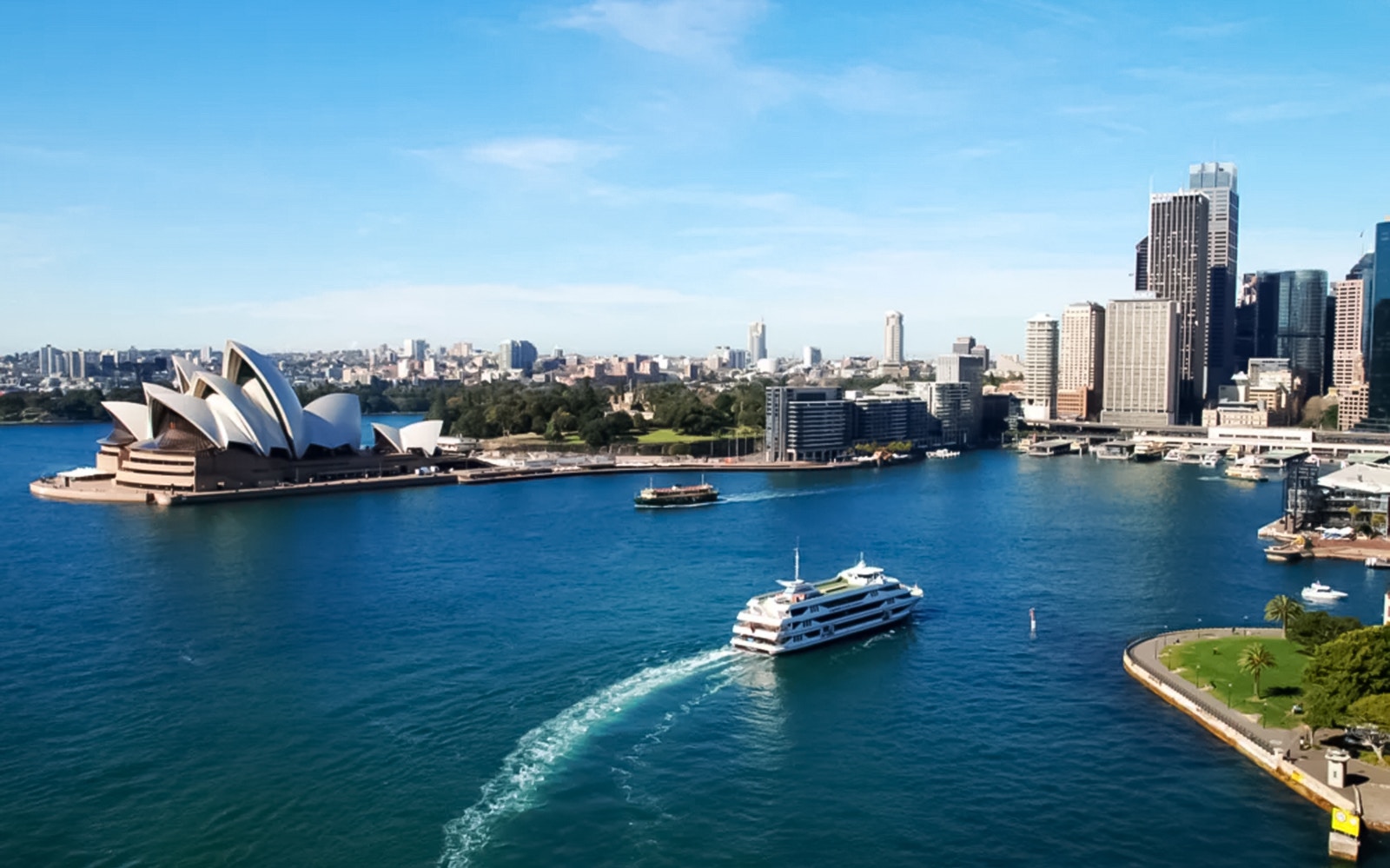Cruise ship near Sydney Opera House on Captain Cook Cocktail Harbour Bar Cruise.