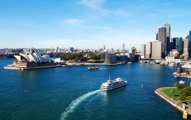 Cruise ship near Sydney Opera House on Captain Cook Cocktail Harbour Bar Cruise.