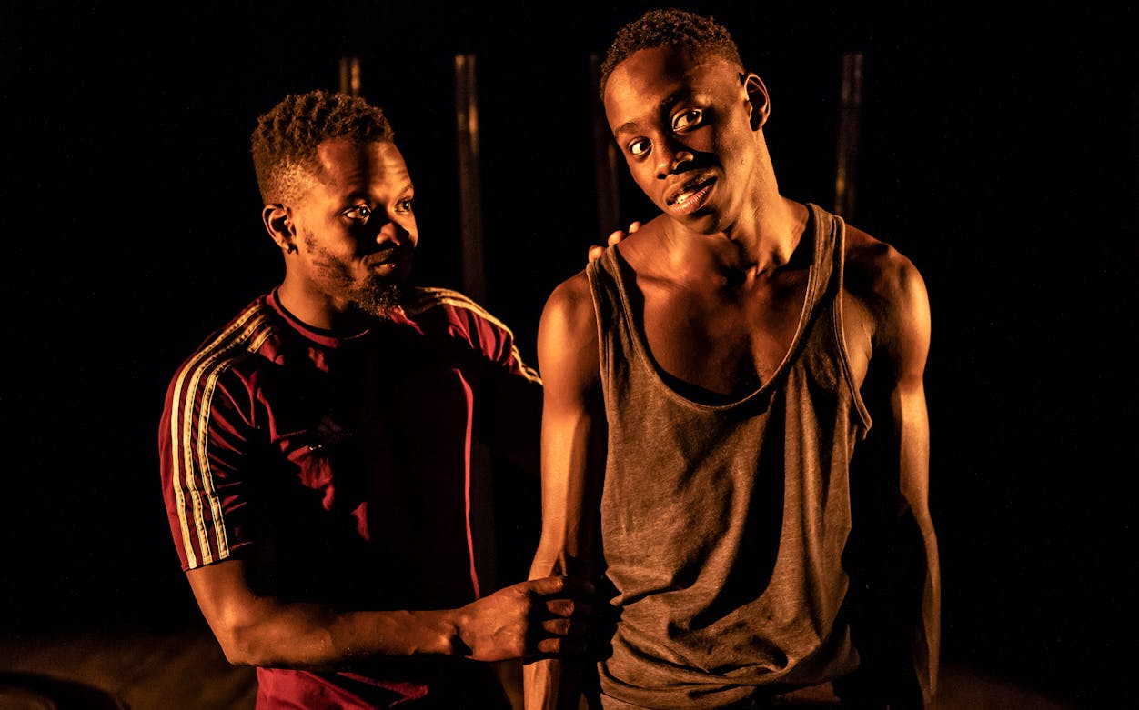 Two actors performing a scene from "The Fishermen" play.