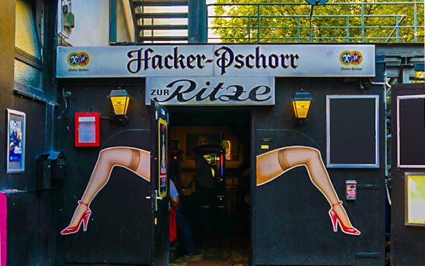 Entrance to Zur Ritze bar in Hamburg St Pauli with iconic leg artwork.