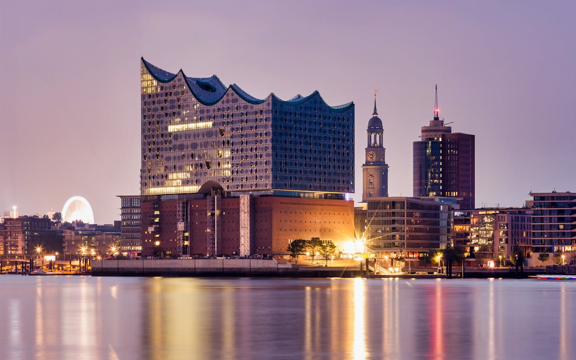 Elbphilharmonie concert hall illuminated at dusk in Hamburg's HafenCity.