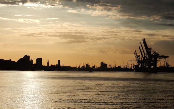 Sunset view of Altona Fish Market with harbor cranes in Hamburg, Germany.