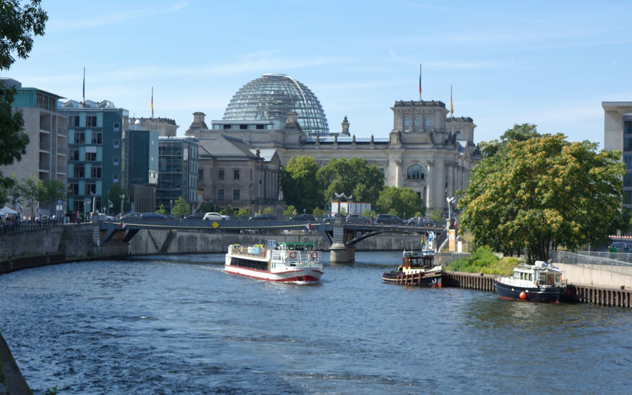 River cruise near the Reichstag building in Berlin during sunset tour.