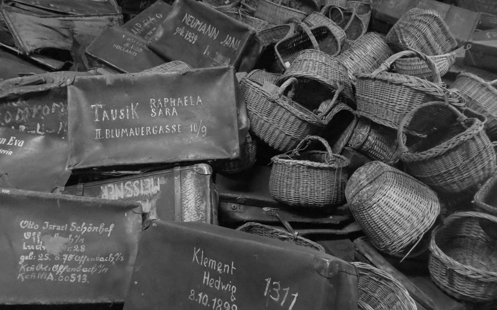 Piles of suitcases and baskets at Auschwitz Birkenau Museum, Krakow tour.
