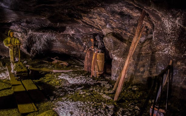 Salt mine exhibit with mannequins depicting miners at work, Krakow tour.