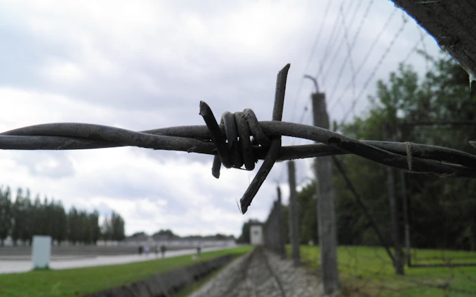 Barbed wire fence at Dachau Concentration Camp Memorial Site, Germany.