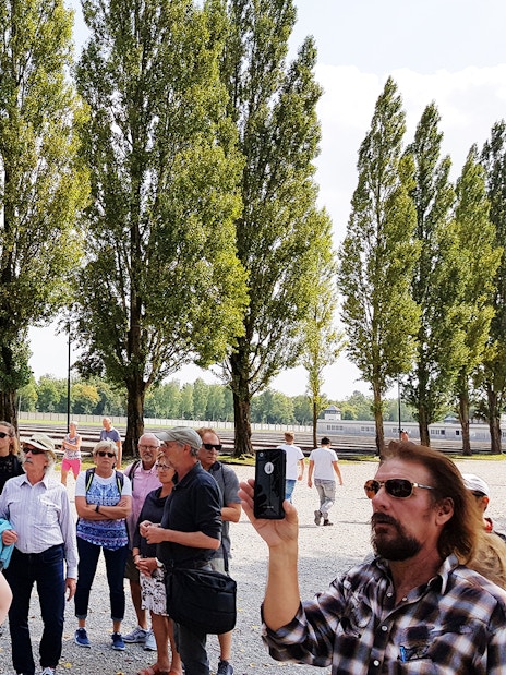 Visitors on a guided tour at Dachau Concentration Camp Memorial Site, Germany.